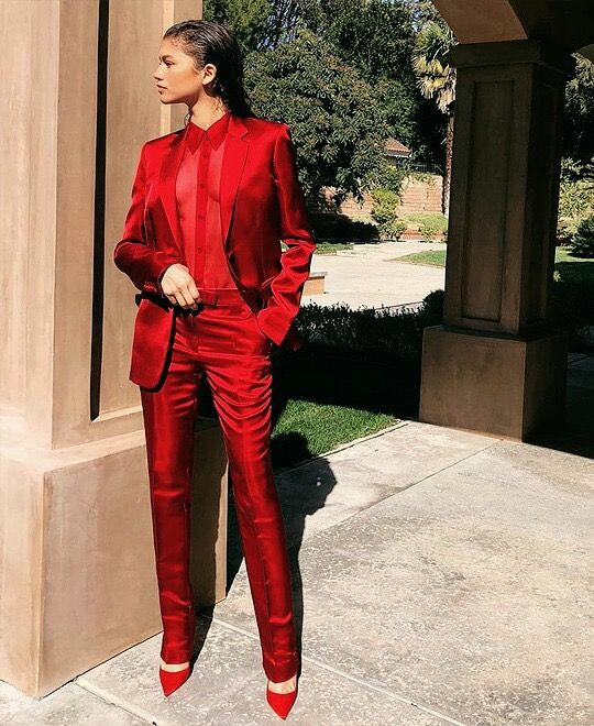 Zendaya in a red feminine suit