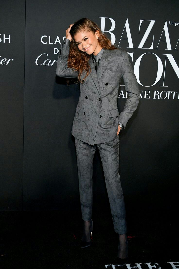 At the Bazaar Icons party in a gray suit