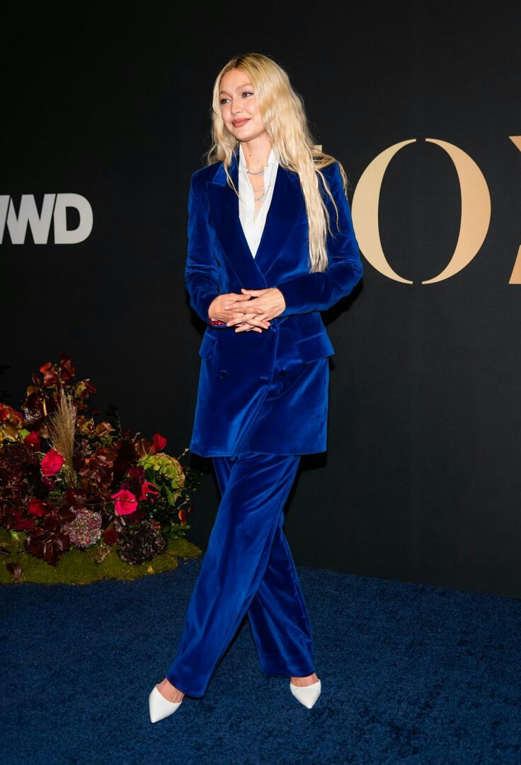 Gigi Hadid attended the WWD Honors Awards in a sporty neon blue velvet suit 