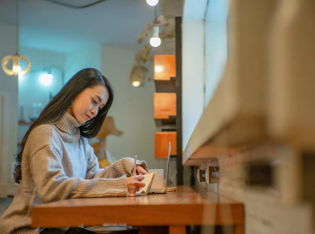 Asian woman writing fashion blog