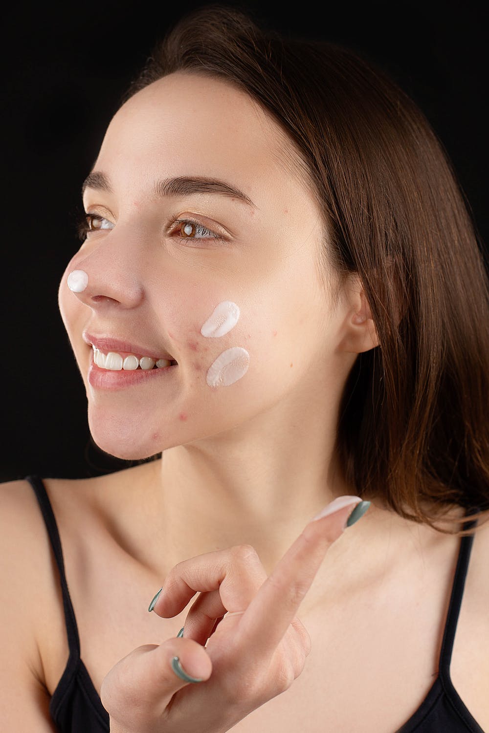 age-defying secrets woman applying cream to face