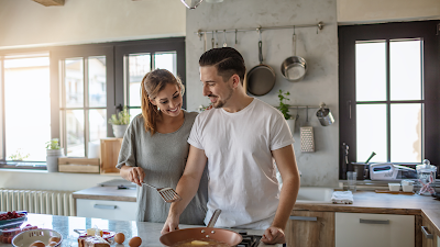 couple cooking eggs