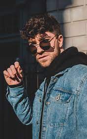 Man in jean jacket wearing sunglasses