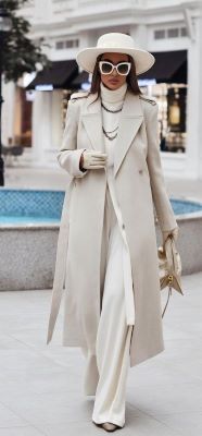 fashion resolutions woman wearing white tutleneck top and white slacks with long white dress jacket