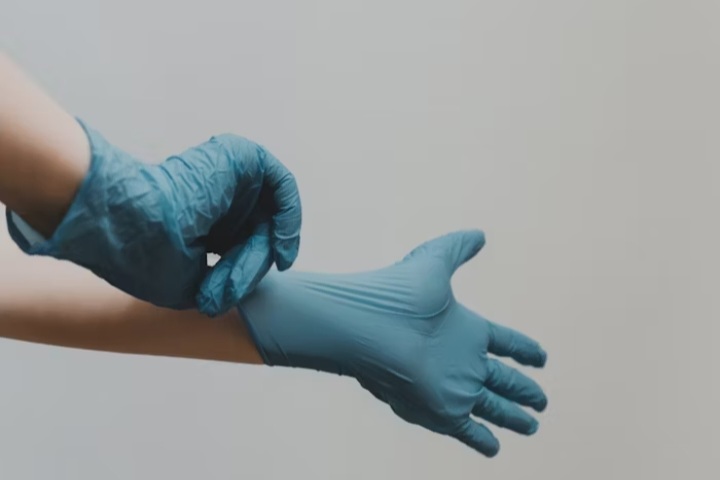 putting on rubber gloves
