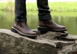 men’s boots man in boots standing on a rock 