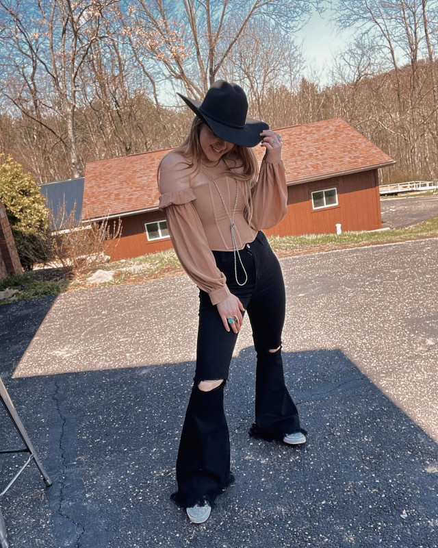 concert outfit ideas black ripped bell bottom jeans