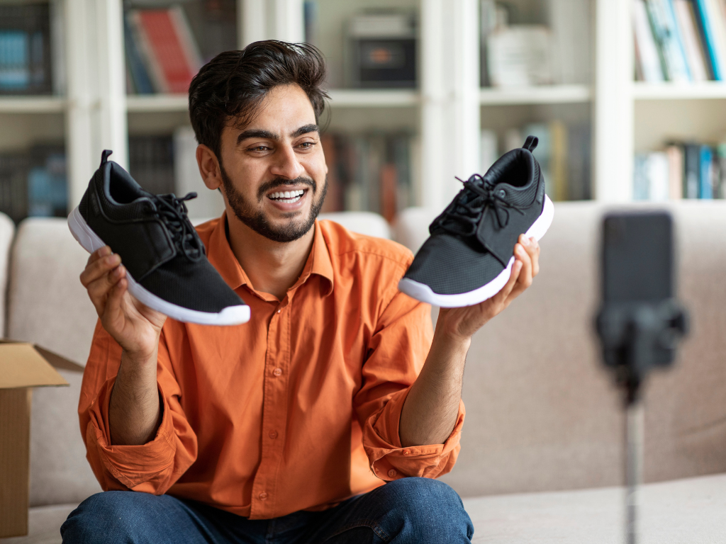 Fashion Blogging featured man holding sneakers in front of camera