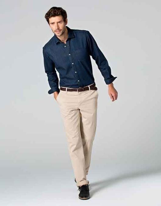 man in blue denim shirt wearing beige chinos