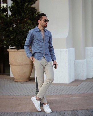 Man wearing sunglasses, blue denim shirt, and beige chinos