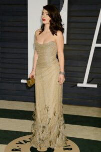 Eve Hewson off-shoulder golden dress