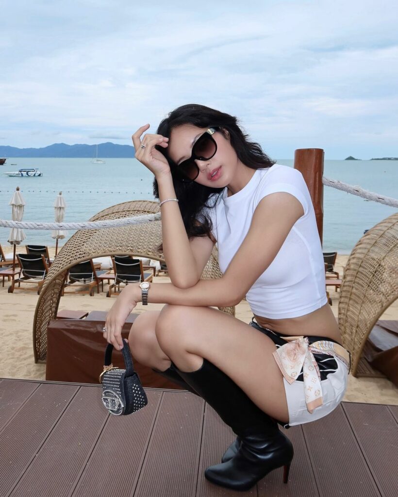 Lisa of Blackpink with hand on head in sunglasses