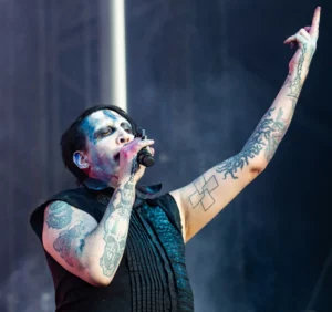 Marlyn displaying his hands tattoos