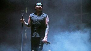 Marilyn Manson tattoo show with his short sleeved blaizer