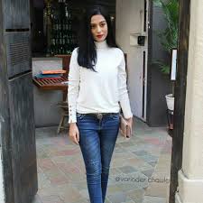 Amrita Rao with her jean paired with a white long-sleeve top