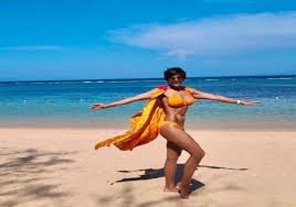 Mandira Bedi colored yellow bikini