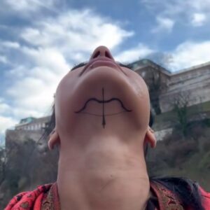 Bani J bow and arrow under check tattoo