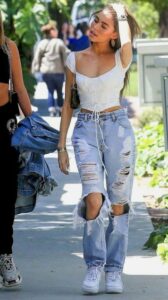 There Is Endless Street Style Inspiration for How to Make Ripped Jeans Look Chic AF | Fashonation Ragged Jeans with a Boho Flowing Top