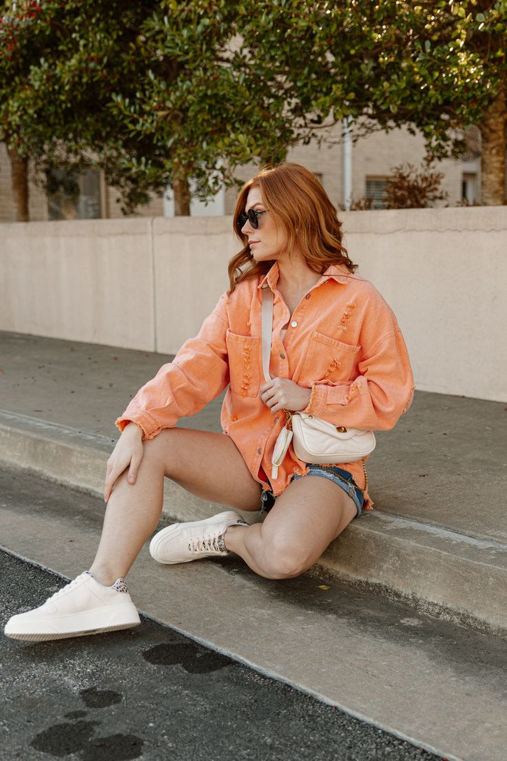 style a shirt with a denim jacket peach top with cutoff jeans