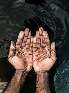 Berber Vitality hands in the water
