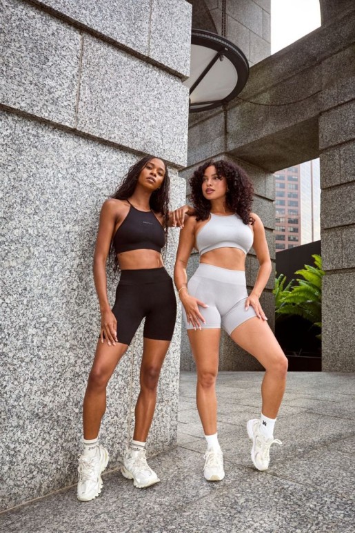 athleisure wear black and gray sports bra and bike shorts