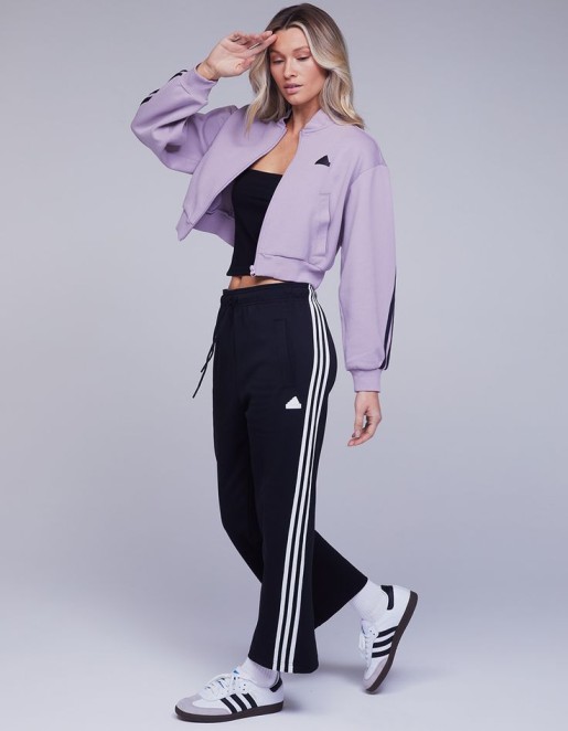 athleisure wear black crop top with purple sweat jacket and adiadas workout pants 