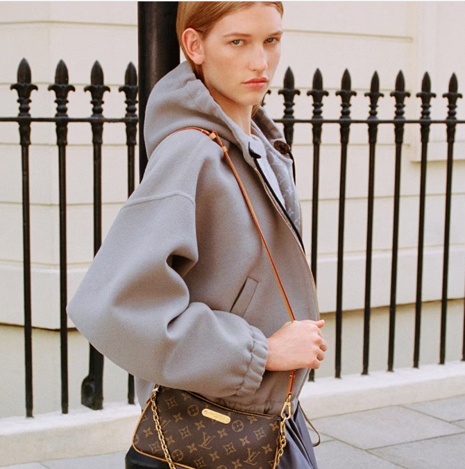 history of Louis Vuitton girl in hoodie with LV bag