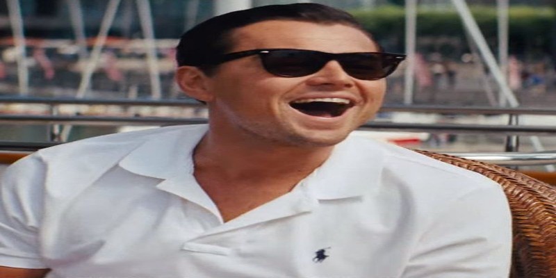 Rock Leonardo DiCaprio Ray-Ban Wayfarer laughing in wicker chair