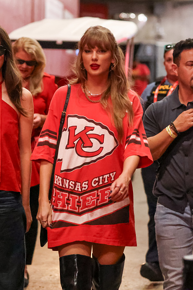 Taylor Swift Fashion Choices for football,in oversized graphic T shirt with KC logo