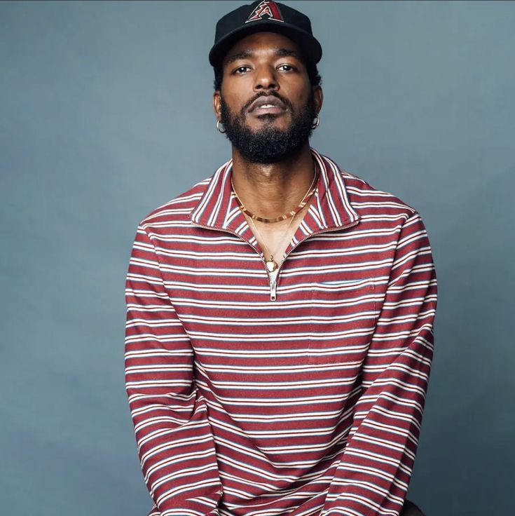 Luke James with striped shirt and hat