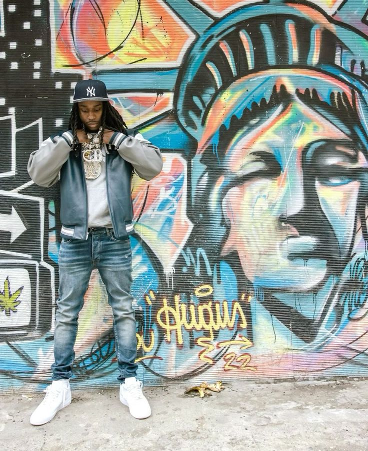 POLO G's style in front of mural 