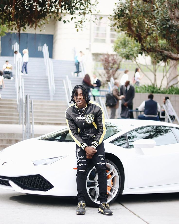 POLO G's style in front of white luxury car