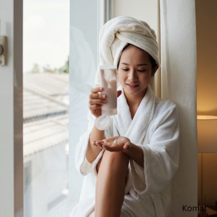 body care routine girl in robe with lotion