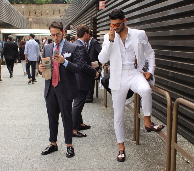 Patent leather loafers talking on phone in white suit