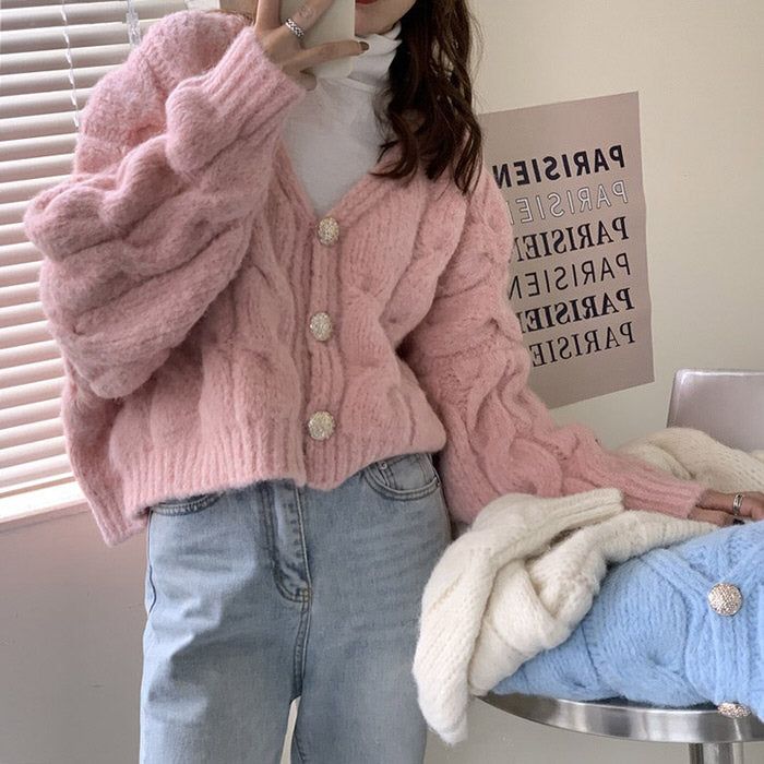 Best Cropped Cotton Cardigans to Upgrade Your Wardrobe girl wearing pink swaeter holding phone