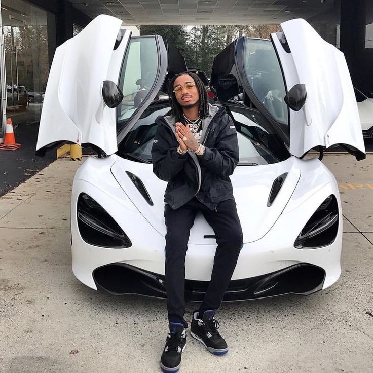 Quavo sitting on car