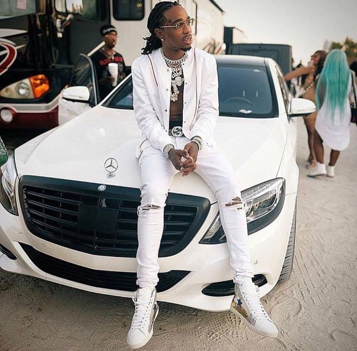 Quavo sitting on white car