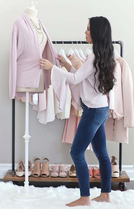 Girl udjusting top on manequin