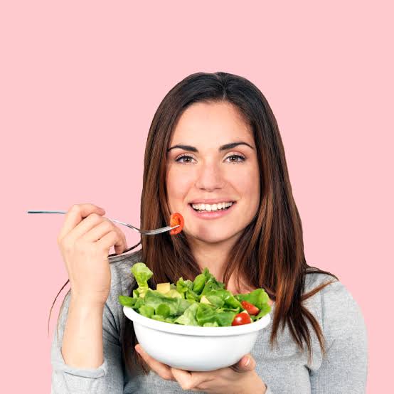 Girl with radiant skin eating salad