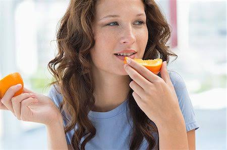 Girl eating oranges