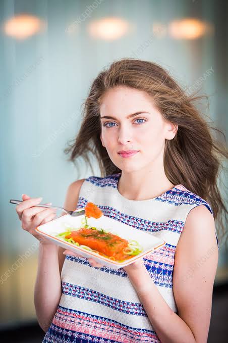 Woman eating fish