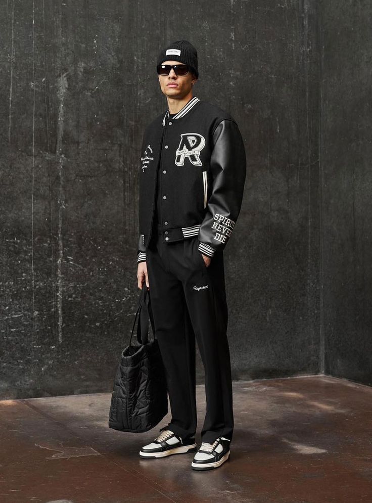 Man in Black bomber jacket wearing sun glasses 