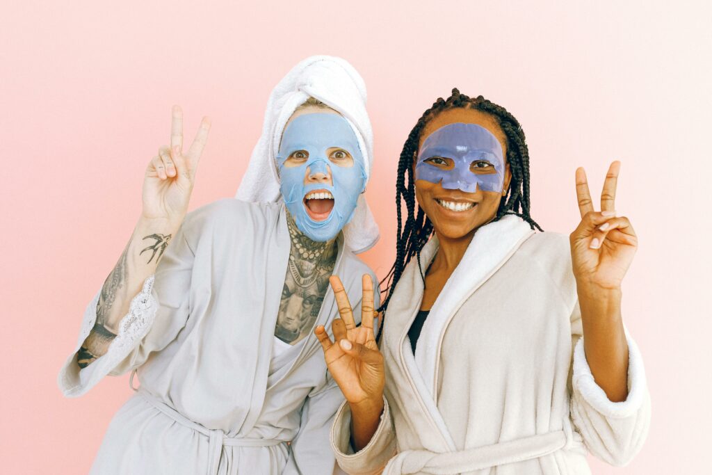 Two women wearing skincare masks