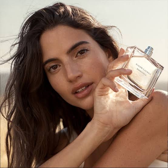 Girl holding bottle of perfume 