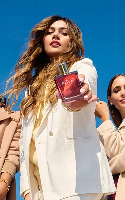 Girl holding alive perfume 