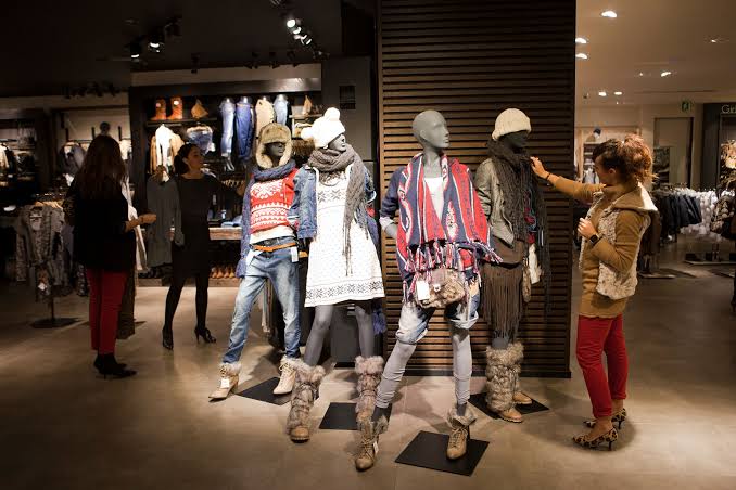 Fast Fashion and Slow Fashion clothes on manequisn in a store