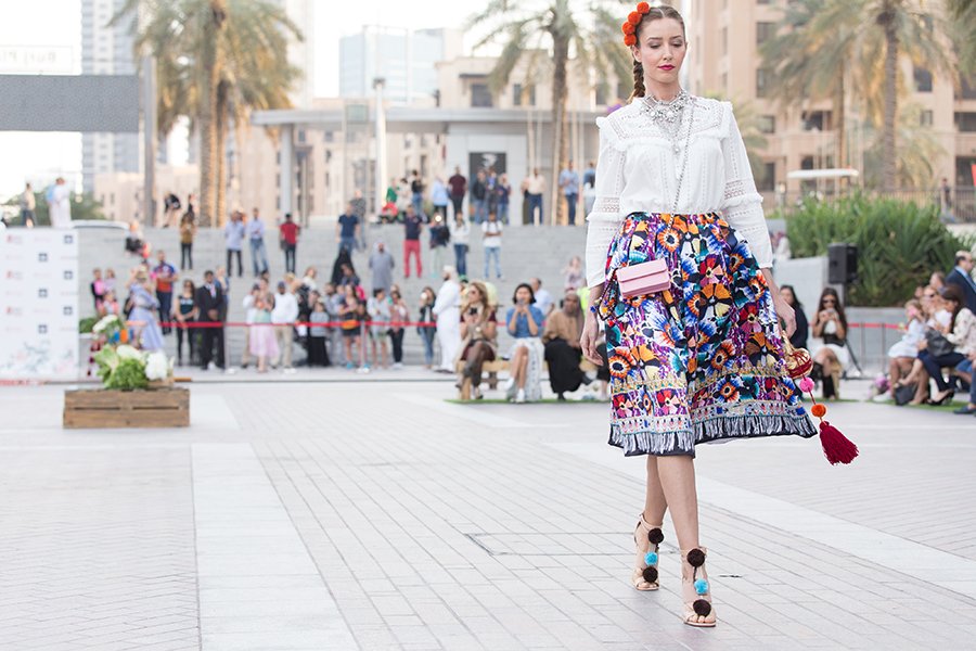 Middle Eastern fashion woman walking in floral skirt 