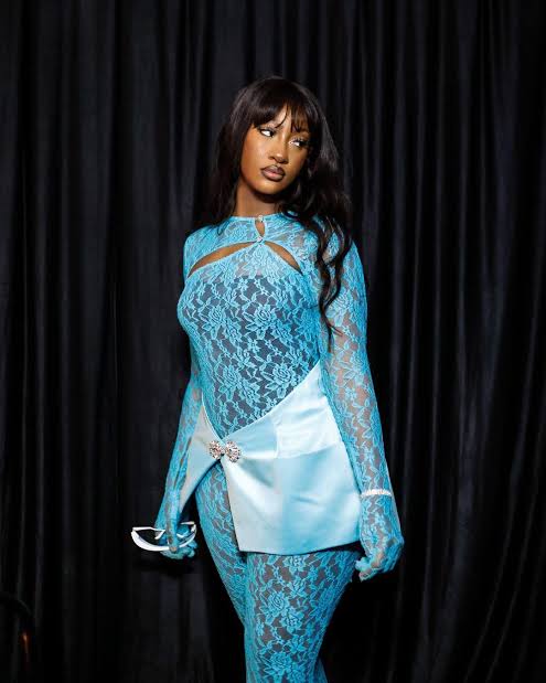 global influences on fashion model in blue lace outfit