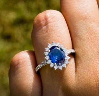 sapphire rings on a finger with diamonds