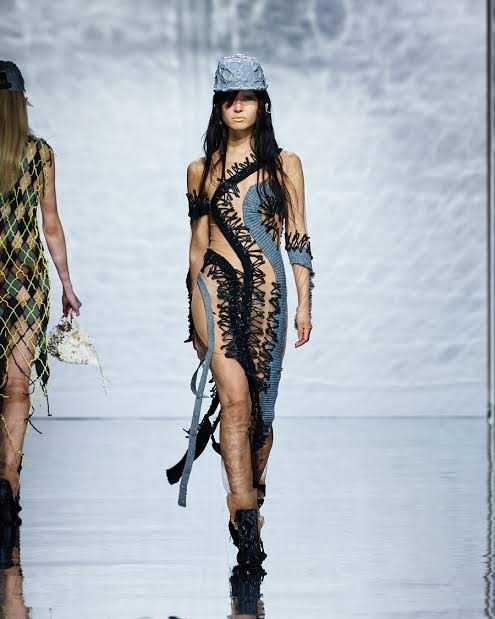 runway model in skimpy blue outfit 